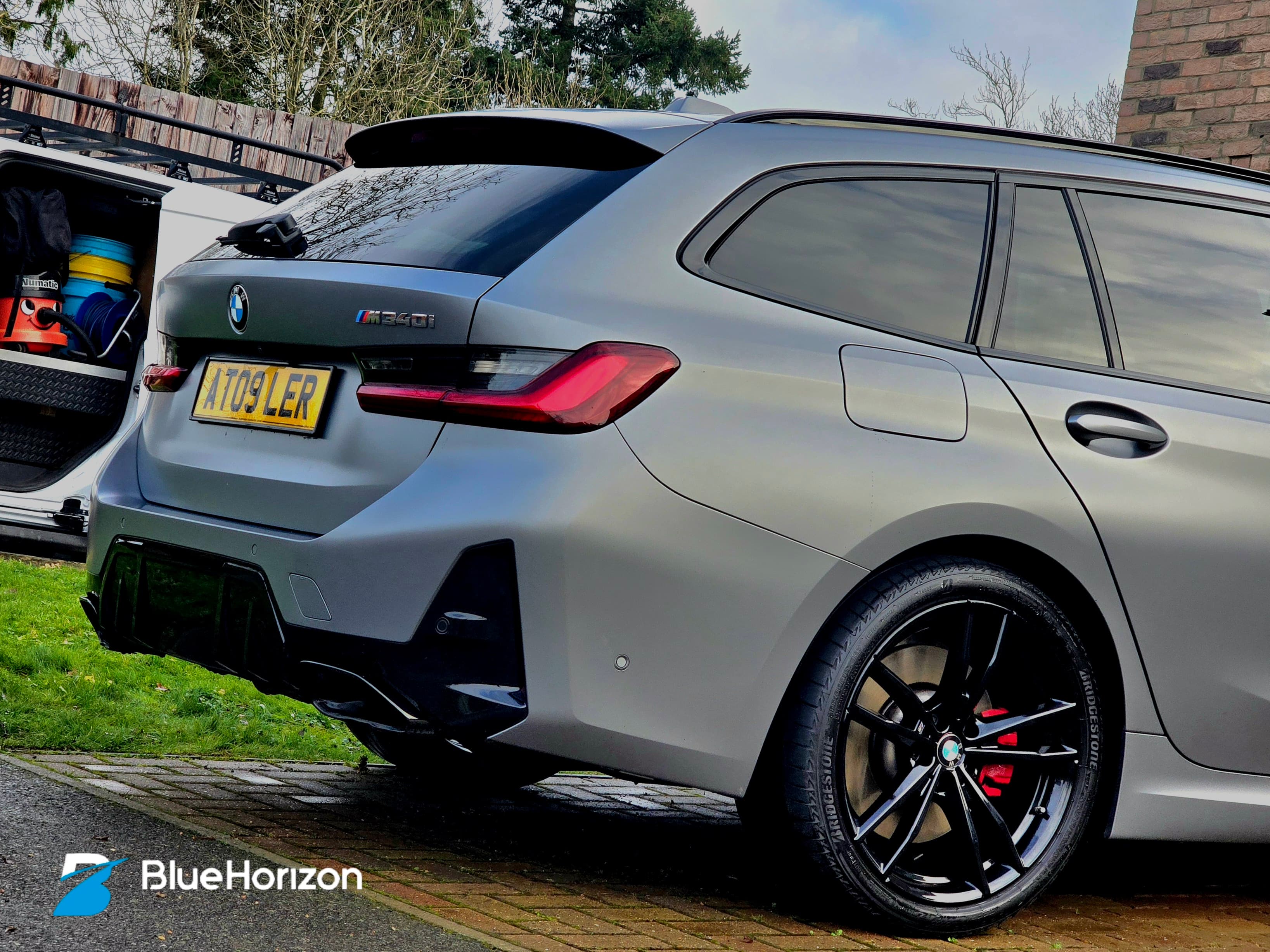 BMW M340i Touring rear quarter showing M340i badge and immaculate matte grey finish after specialist care