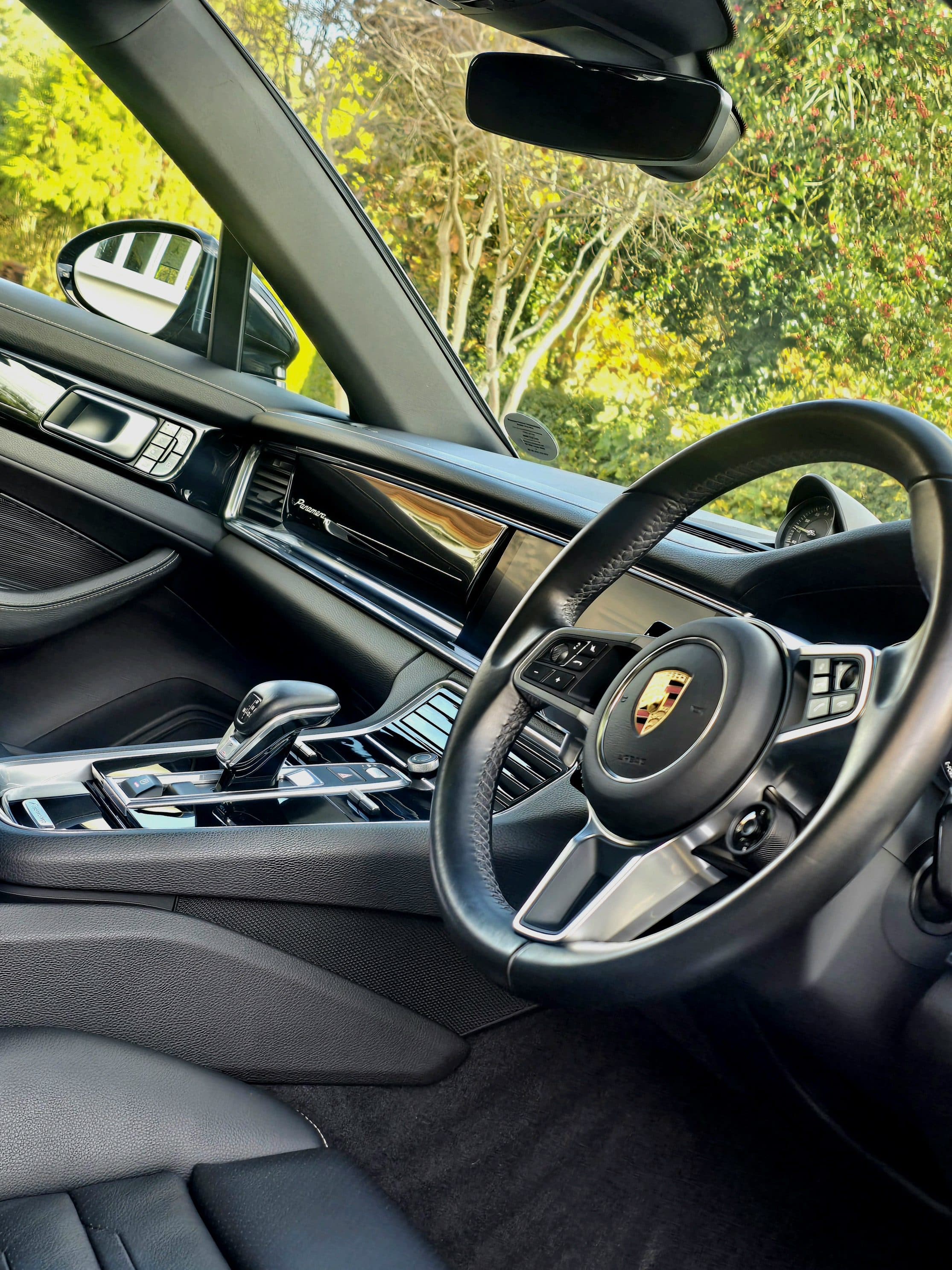 Pristine Porsche Panamera interior showing spotless steering wheel, touchscreen and alcantara after Blue Horizon deep clean, Warwickshire