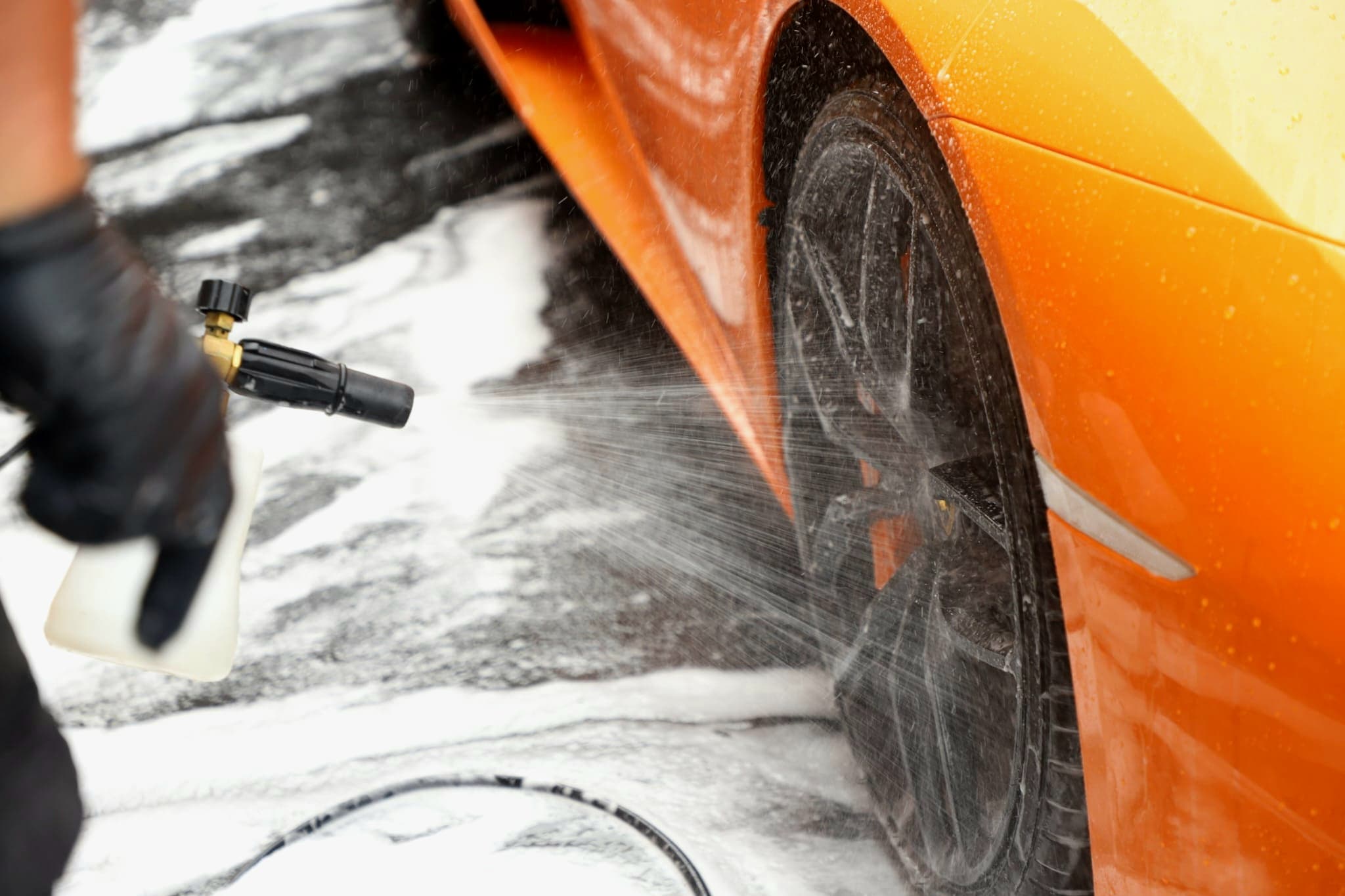 High-pressure rinse of Lamborghini Huracan wheel arch — removing contamination before wash