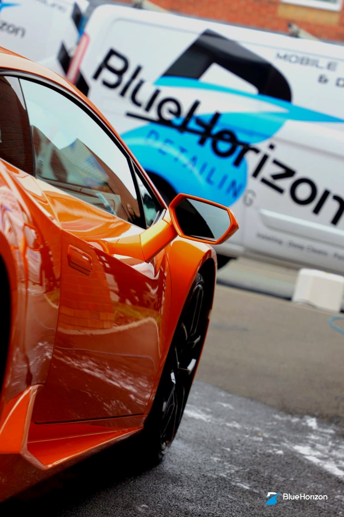 Side profile of orange Lamborghini Huracan with Blue Horizon Detailing van — mobile detail Warwickshire