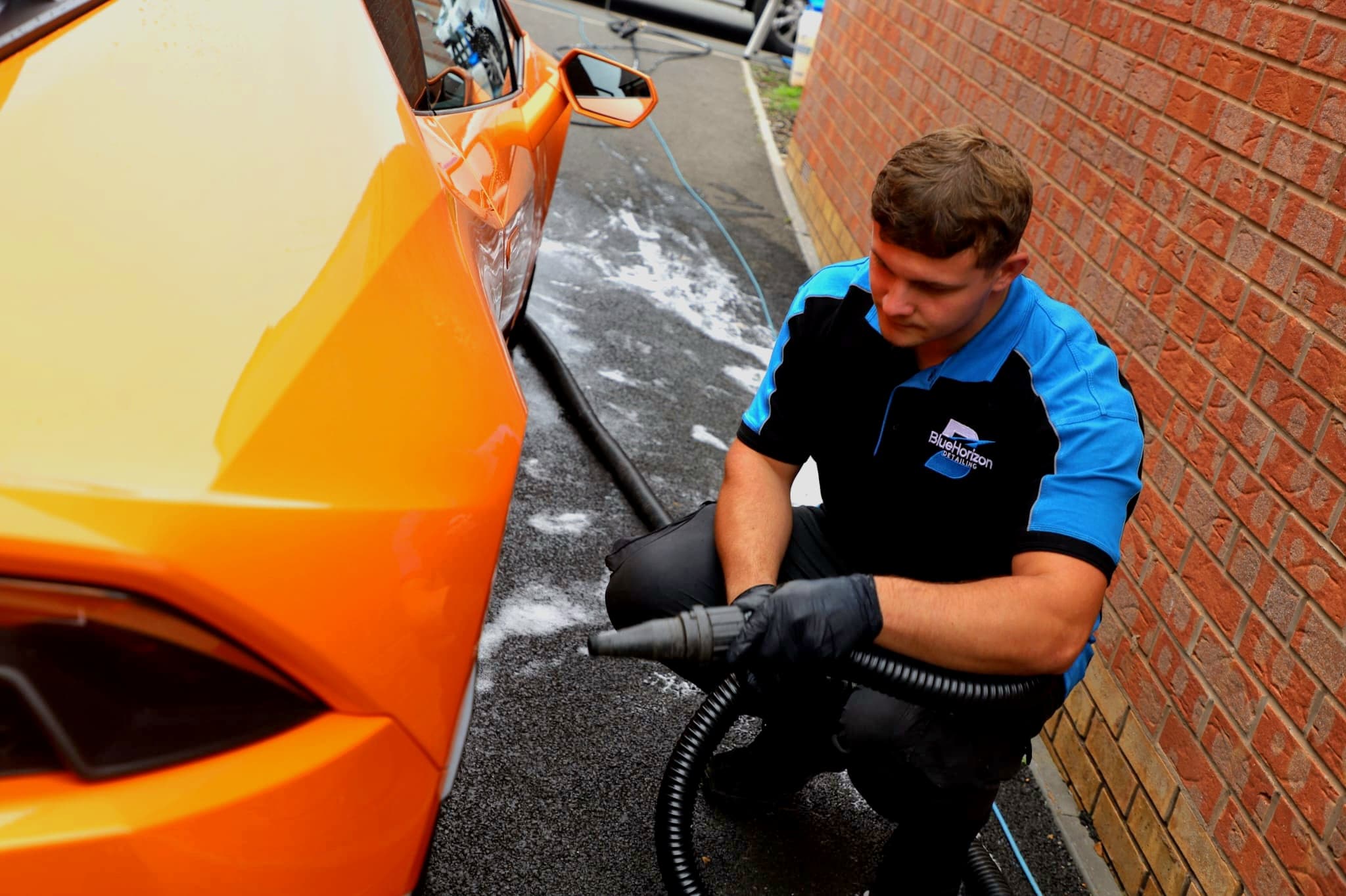 Steam cleaning the wheel arch and sill area of Lamborghini Huracan — thorough detailing process
