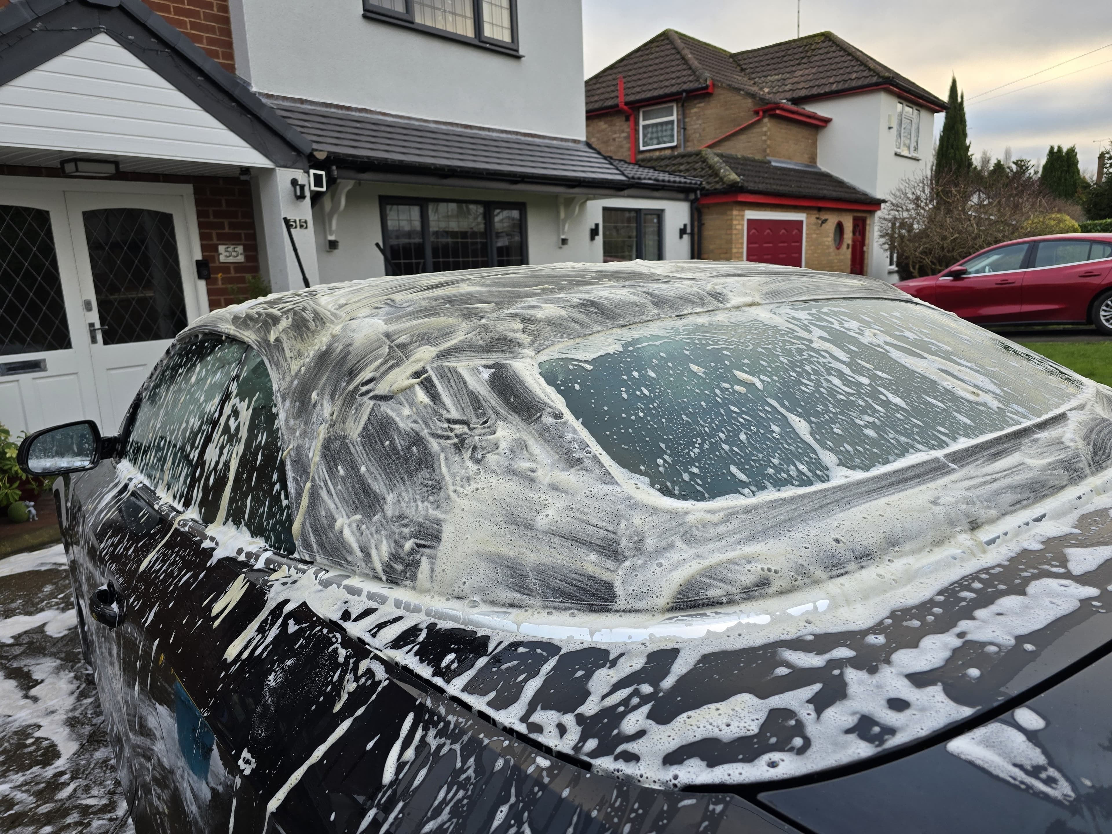 Tesla Model 3 being snow-foamed and washed by Blue Horizon Detailing — maintenance valet result Warwickshire