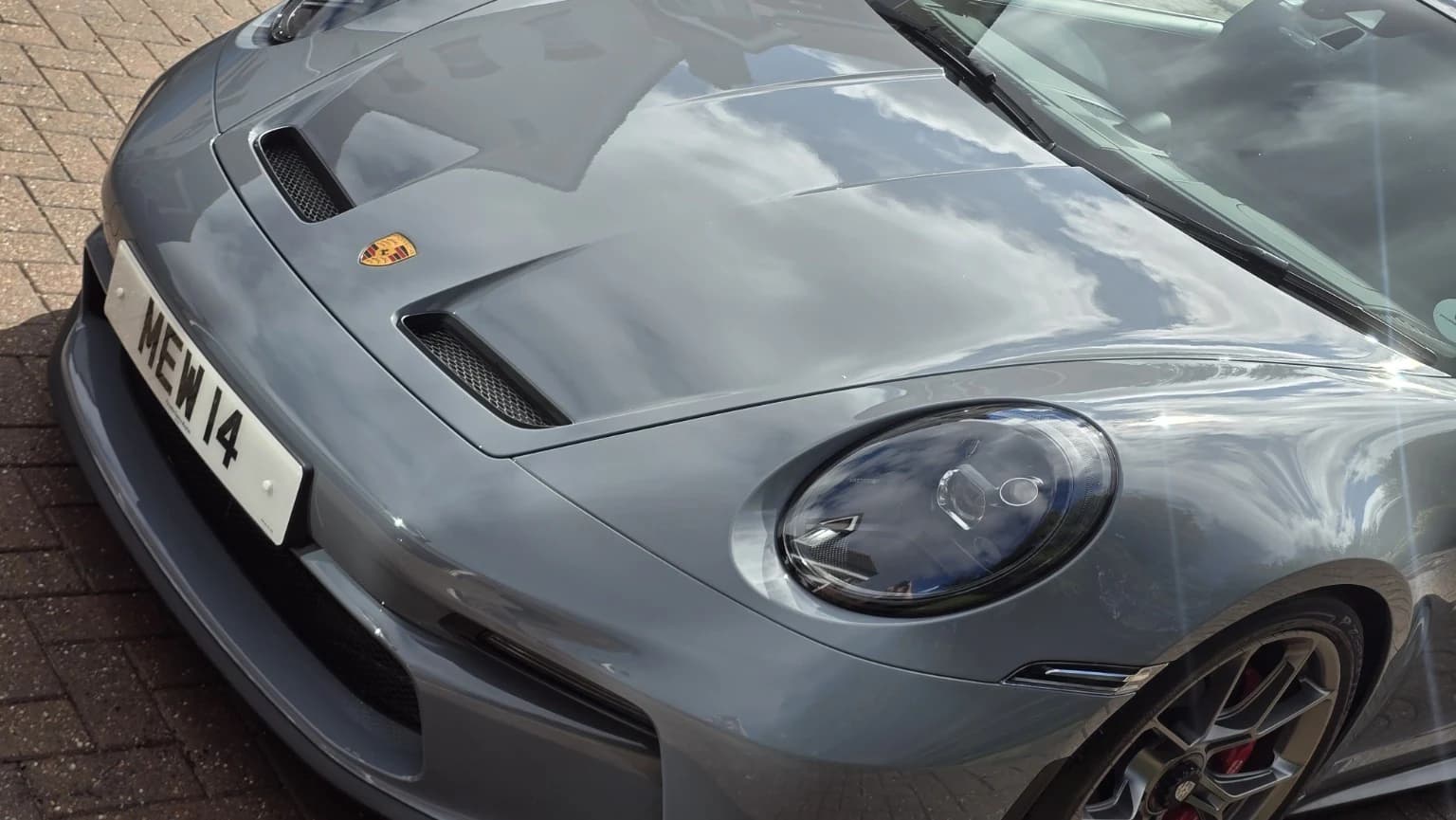 Grey Porsche GT3 with a crisp, reflective finish