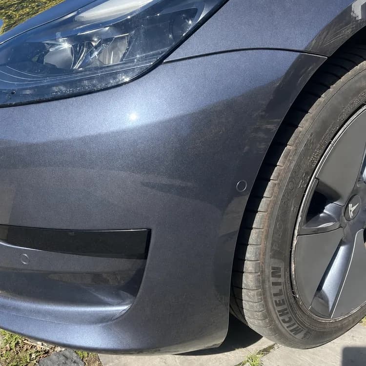 Illustrated repaired finish on the same bumper, not a completed customer repair