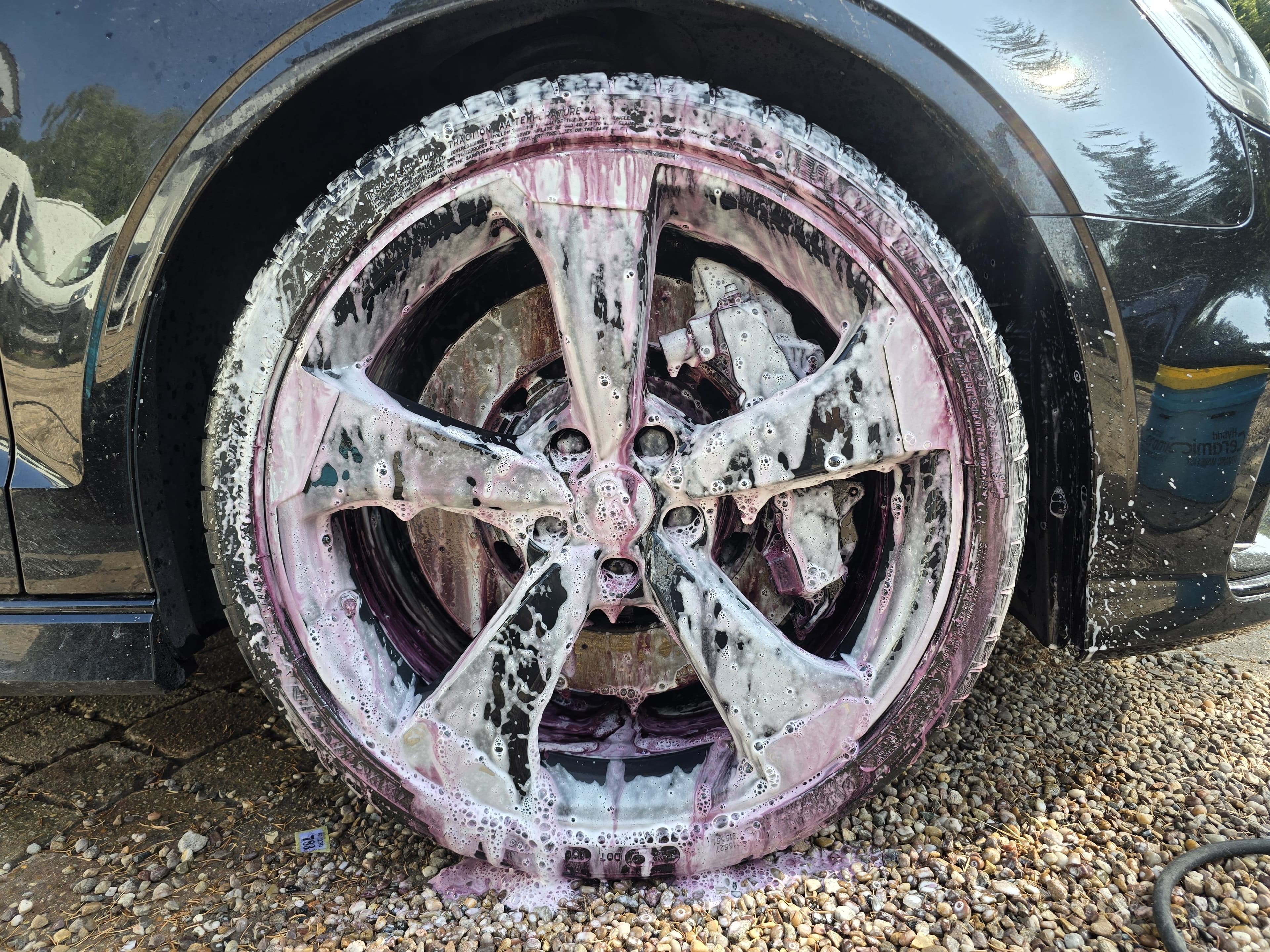 Wheel decontamination removing iron fallout on a car in Warwickshire by Blue Horizon Detailing