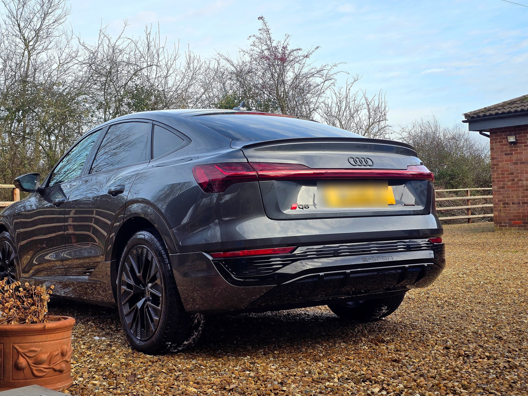 Rear three-quarter of a clean grey Audi Q8 e-tron Sportback after a Maintenance Plus valet