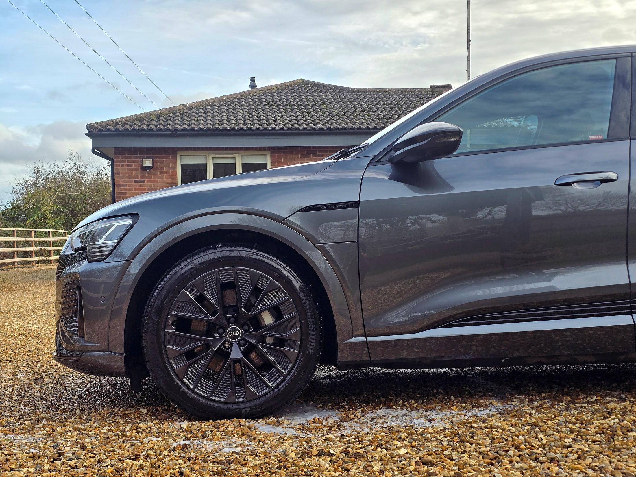 Gloss black alloy wheel on a grey Audi Q8 e-tron, cleaned and detailed