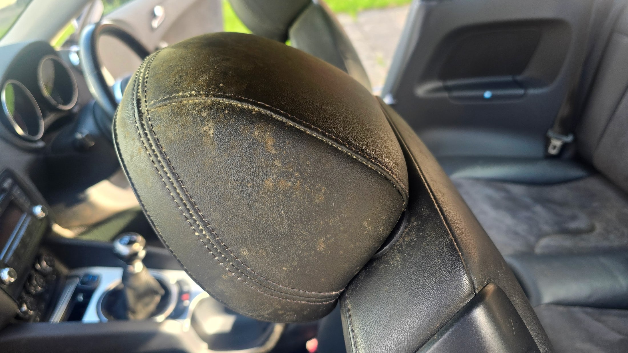 Mould growing on the leather headrest of an Audi TT before cleaning